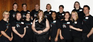 The AccessibilityOz team: Gian Wild with thirteen staff, wearing black AccessibilityOz tshirts